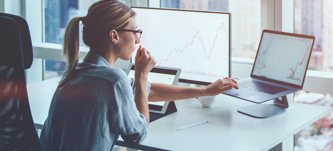 Stock image of woman wearing glasses sitting at a computer